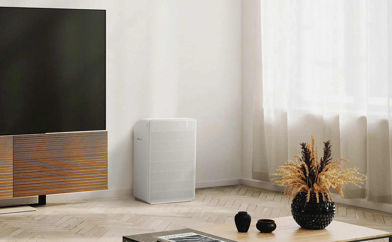 CUCKOO R Model beside a TV console